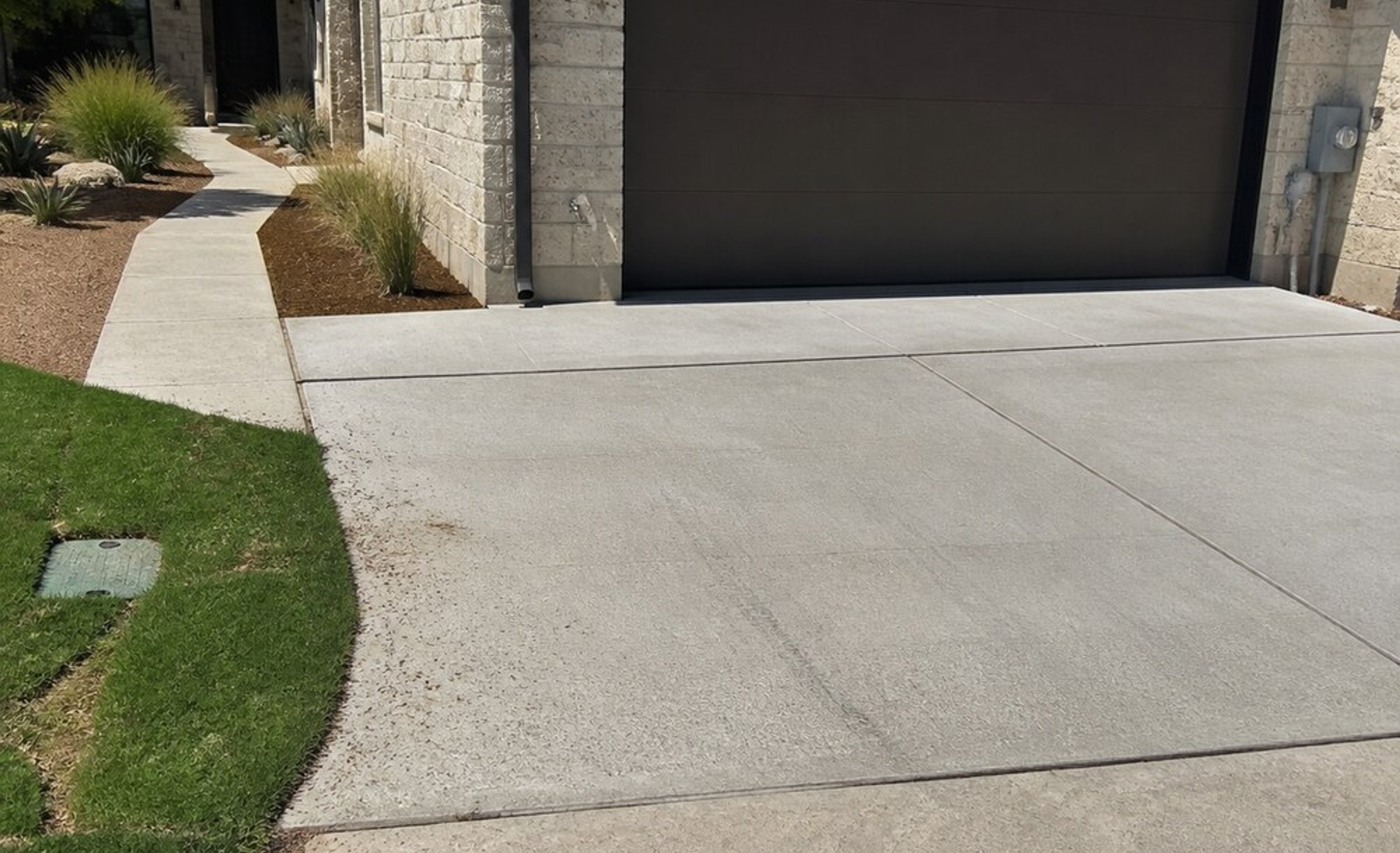 Concrete driveway apron at an Austin garage