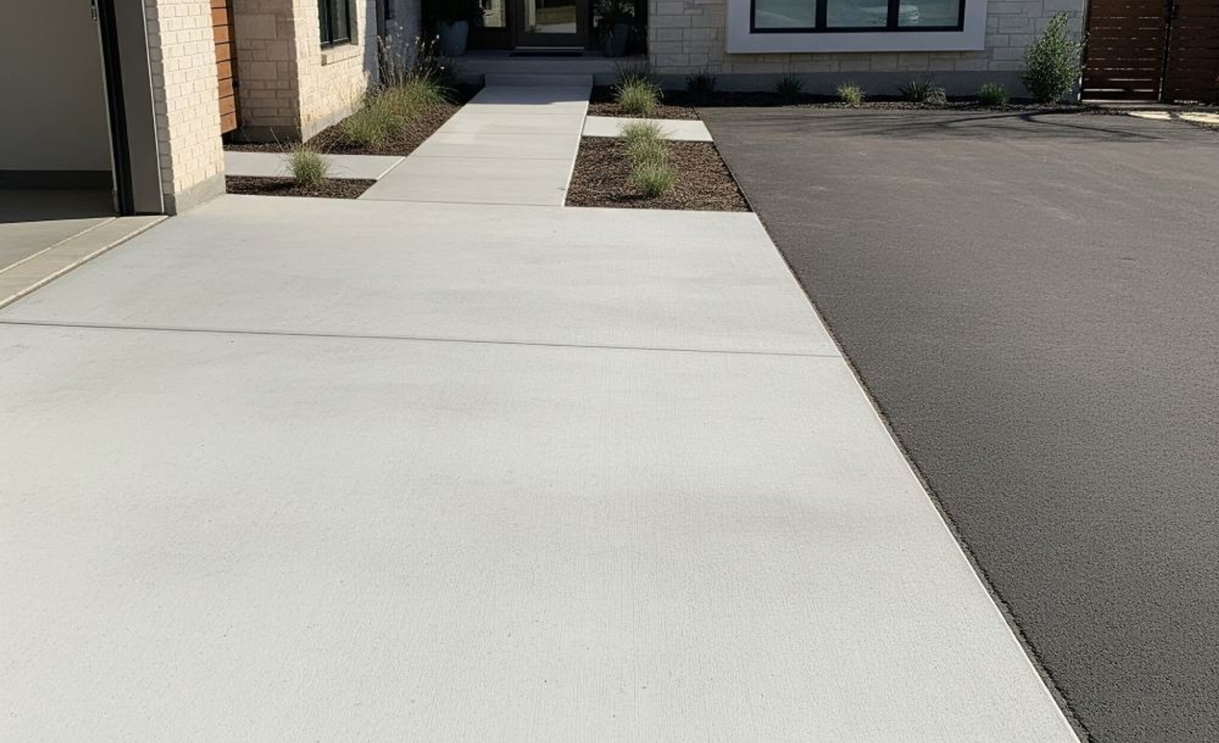 Concrete driveway apron at an Austin garage