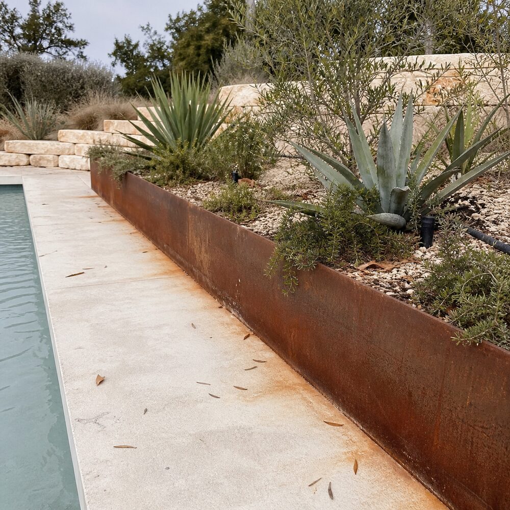 Weathering steel planter edging a pool deck in Austin, TX