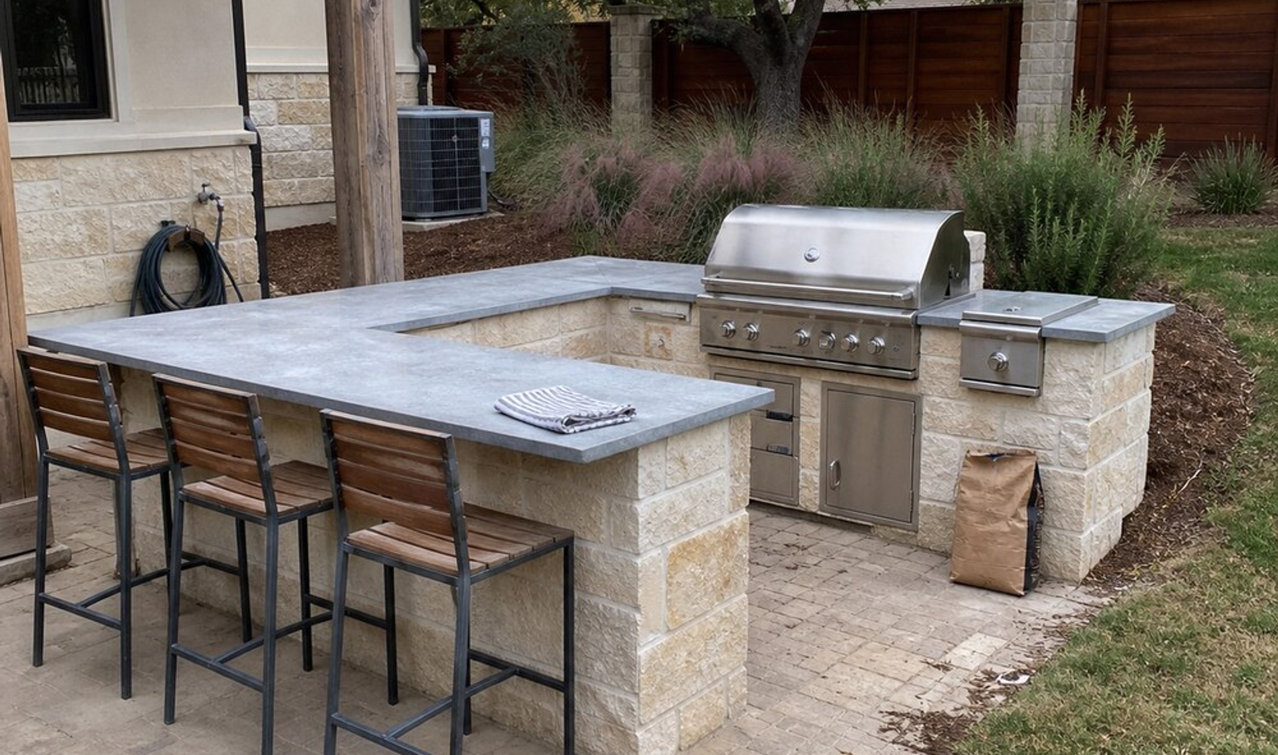 stone outdoor kitchen in an Austin backyard