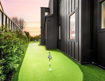 backyard-mini-golf-course-beside-a-modern-black-ho-2024-10-02-19-47-27-utc