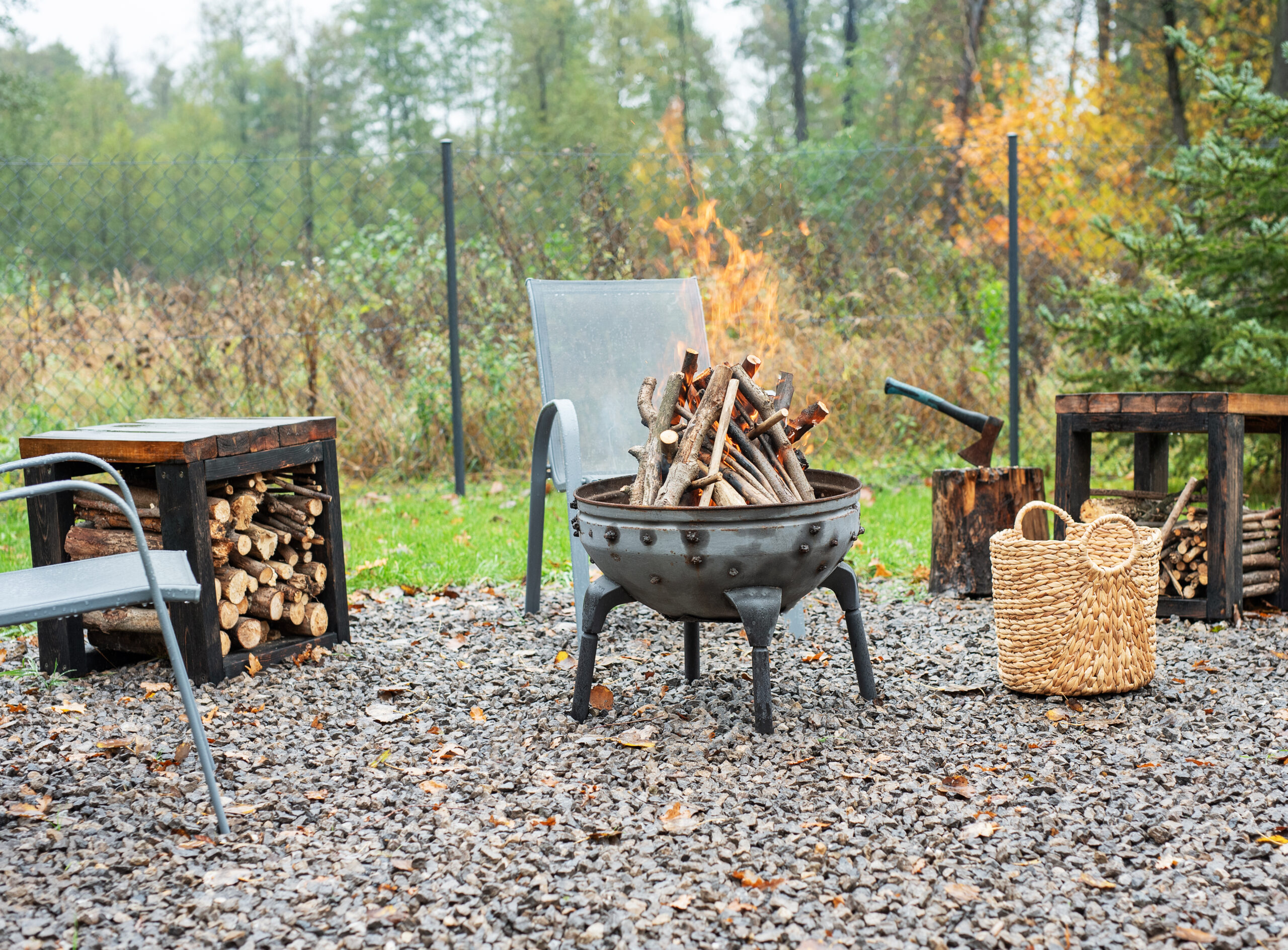 Iron fire pit and burning fire in a garden