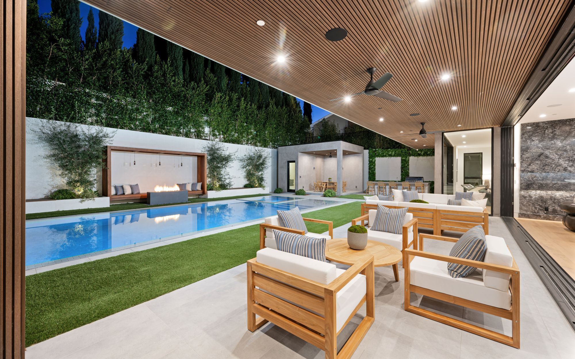 lush-green-patio-boasts-an-expansive-pool-and-invi-2024-01-22-20-47-51-utc