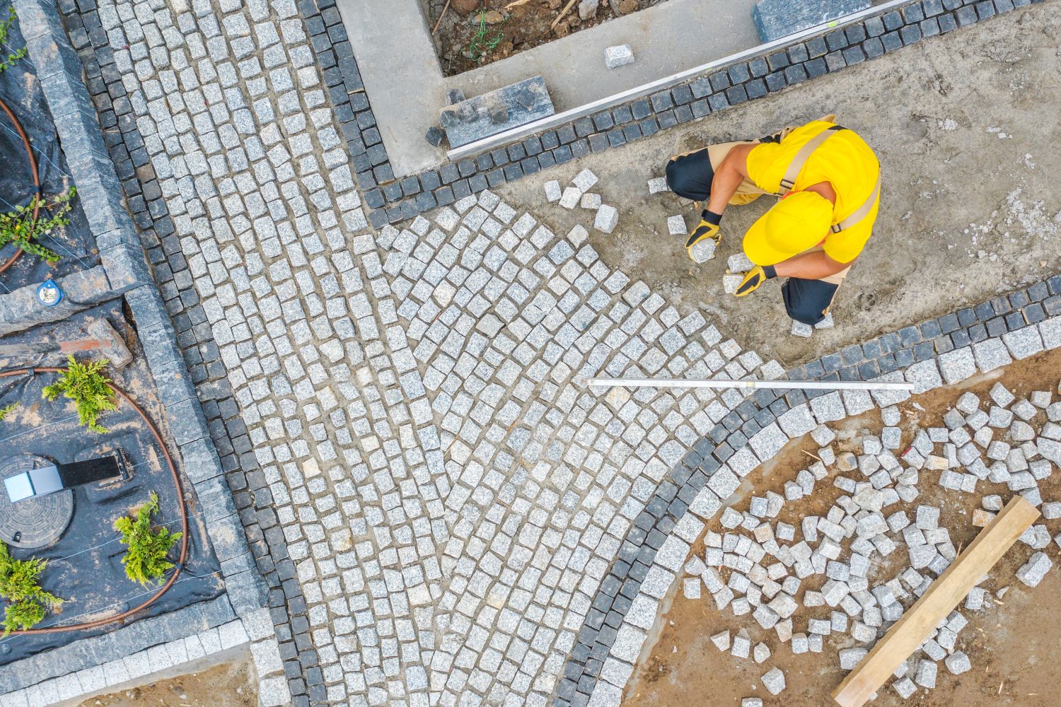 worker-paving-garden-path-aerial-vista-2023-11-27-05-09-58-utc